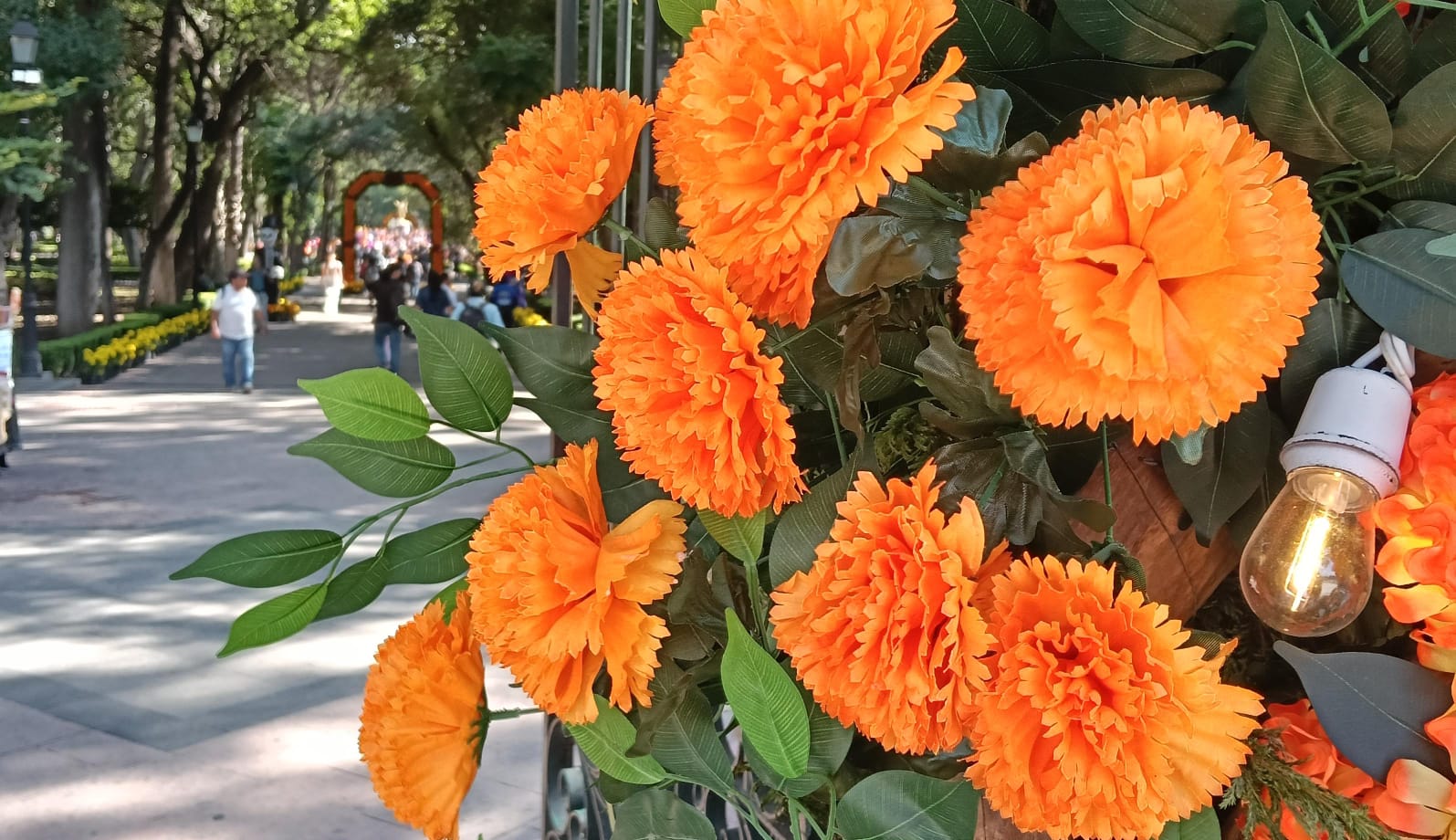 Adornan la puerta de la Alameda con flor de Cempasúchil sintética y china